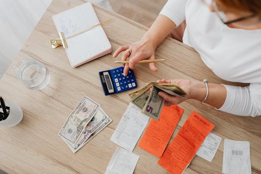 person budgeting with calculator and notebook